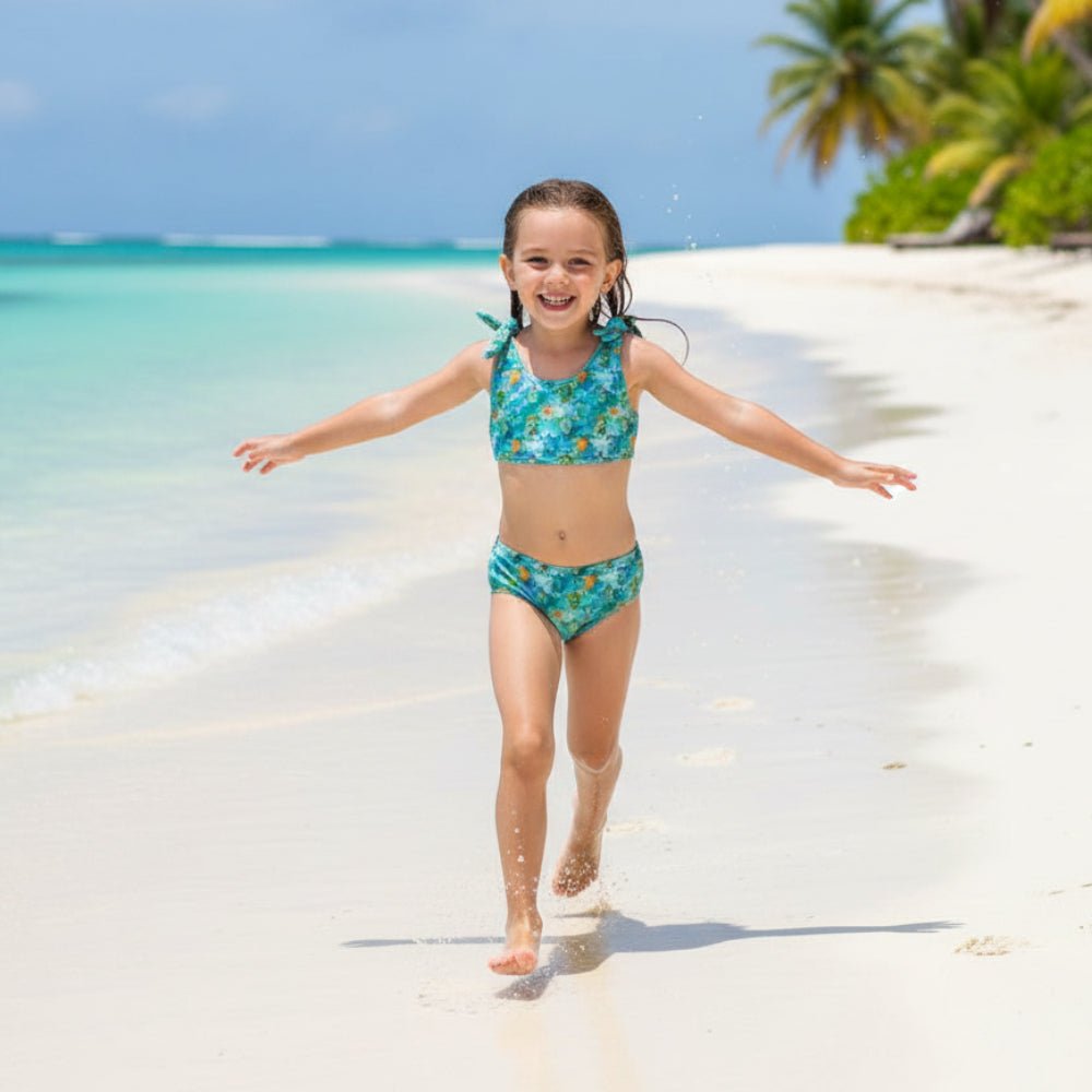Cute little girl wearing a Sea Turtle Pattern Bikini with turtle pattern running and playing on a Hawaiian Island beach