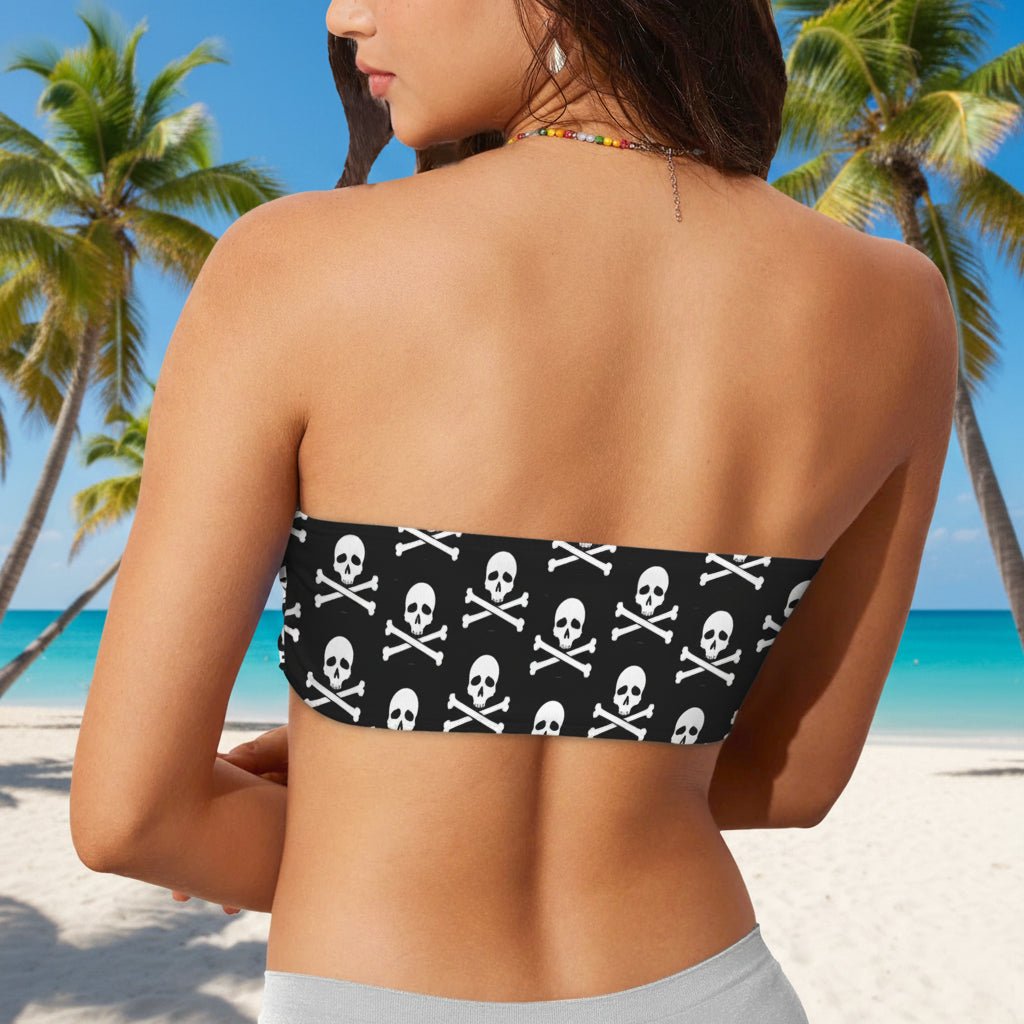 Woman wearing a strapless bikini top with skull and crossbones pattern on a beach in Key West.