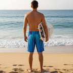 Dude wearing Multi colored striped shorts watching the tide come in on Waikiki Beach