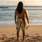 Dude wearing Colorful tropical floral shorts checking out the waves from a beach in Hawaii