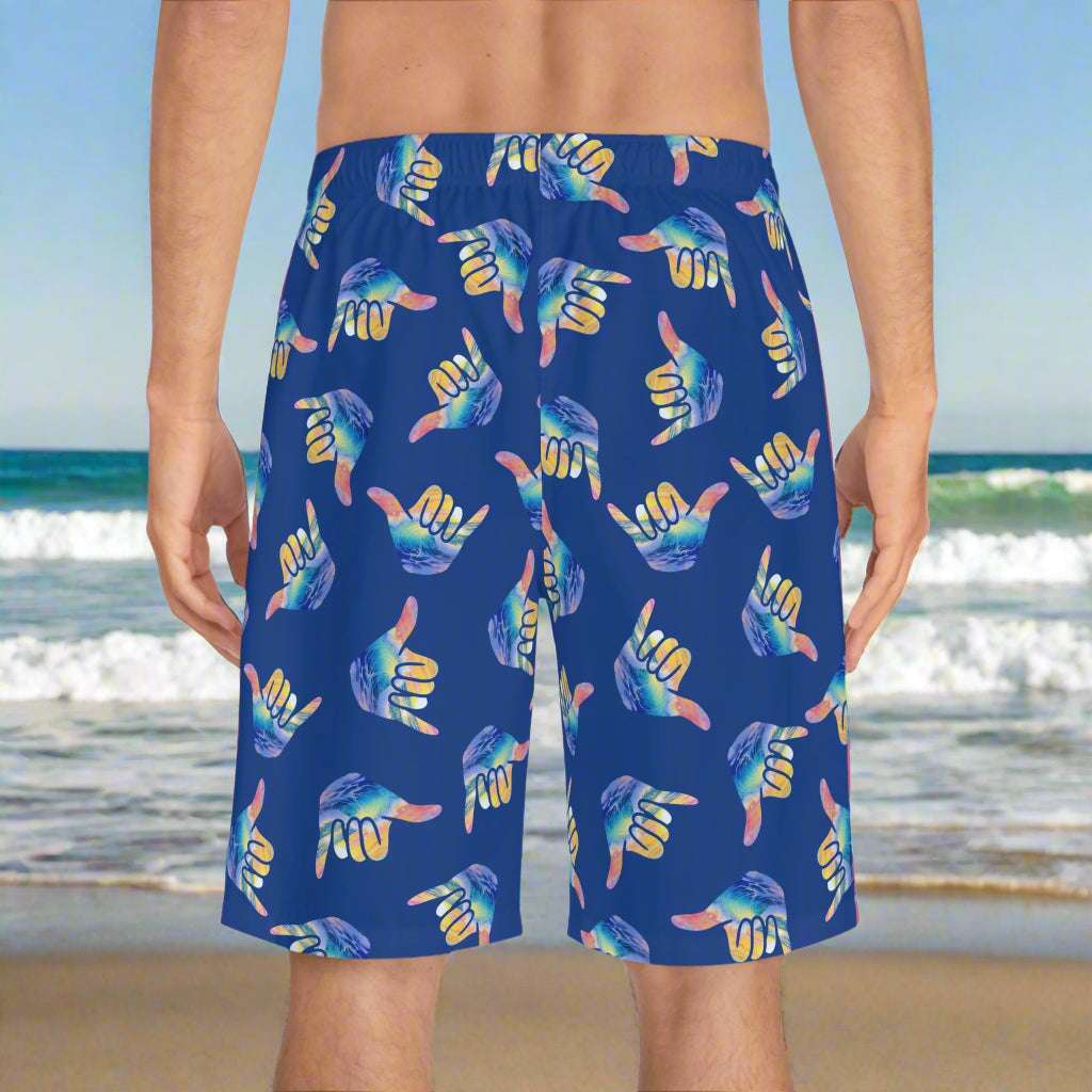 Surfer wearing Bongo Beachwear Boardshorts standing the beach waiting for high tide.
