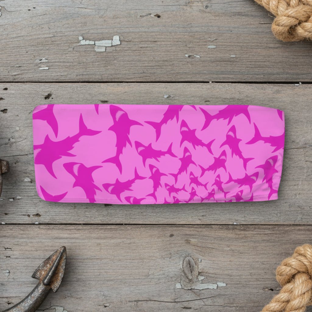 Pink shark patterned bandeau swim top on a wood background
