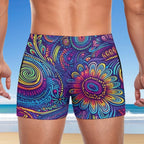 Colorful patterned swim shorts with a beach background