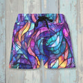 Colorful leaf-patterned shorts on a rustic wood background