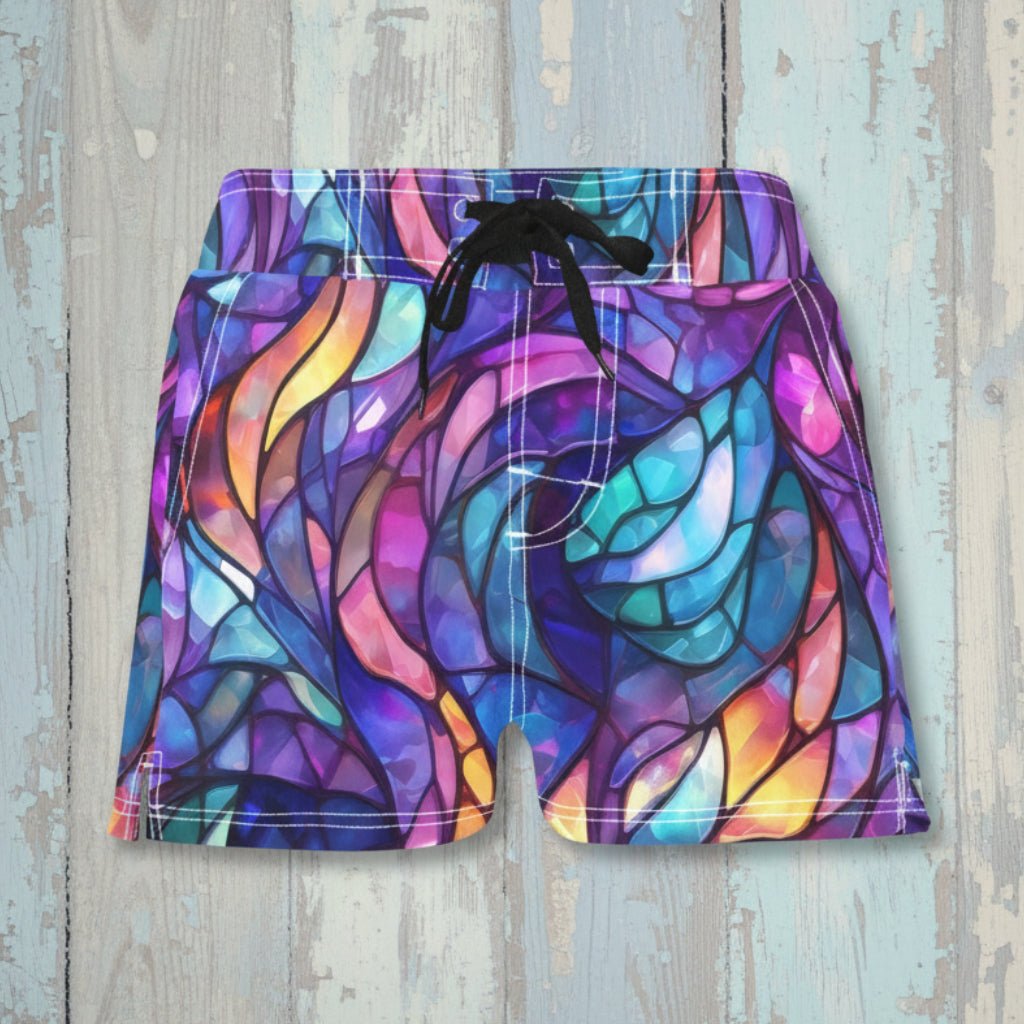 Colorful leaf-patterned shorts on a rustic wood background