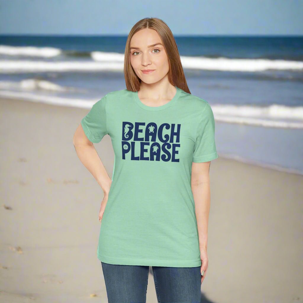 Woman wearing a green t-shirt with 'Beach Please' text on a beach.