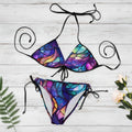 Colorful bikini set with a stained glass design on a white nautical wood background