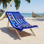 Colorful beach towel with animal patterns on a wooden chair at a beach.