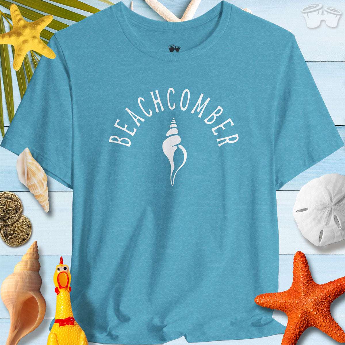 Beachcomber shelling t-shirt featured among seashells and starfish, perfect for summer beach adventures.
