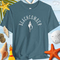 Beachcomber shelling t-shirt displayed with seashells and beach-themed items, perfect for beach adventures.