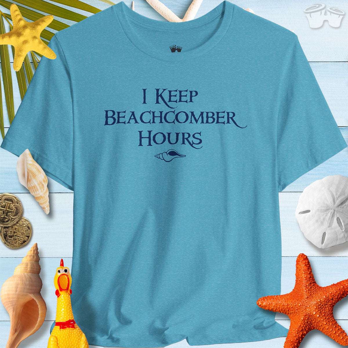 Beachy Bella Shelling T-Shirt in blue with "I Keep Beachcomber Hours" text, perfect for beach lovers.