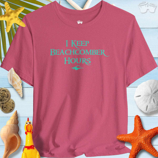 Beachcomber Hours Shelling T-Shirt by Beachy Bella on a beachy background with seashells and tropical decor.