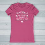 Pink t-shirt with a white emblem design on a nautical wood  background