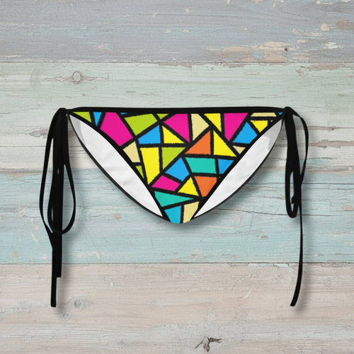 Colorful geometric-patterned bikini bottom with black straps on a white background