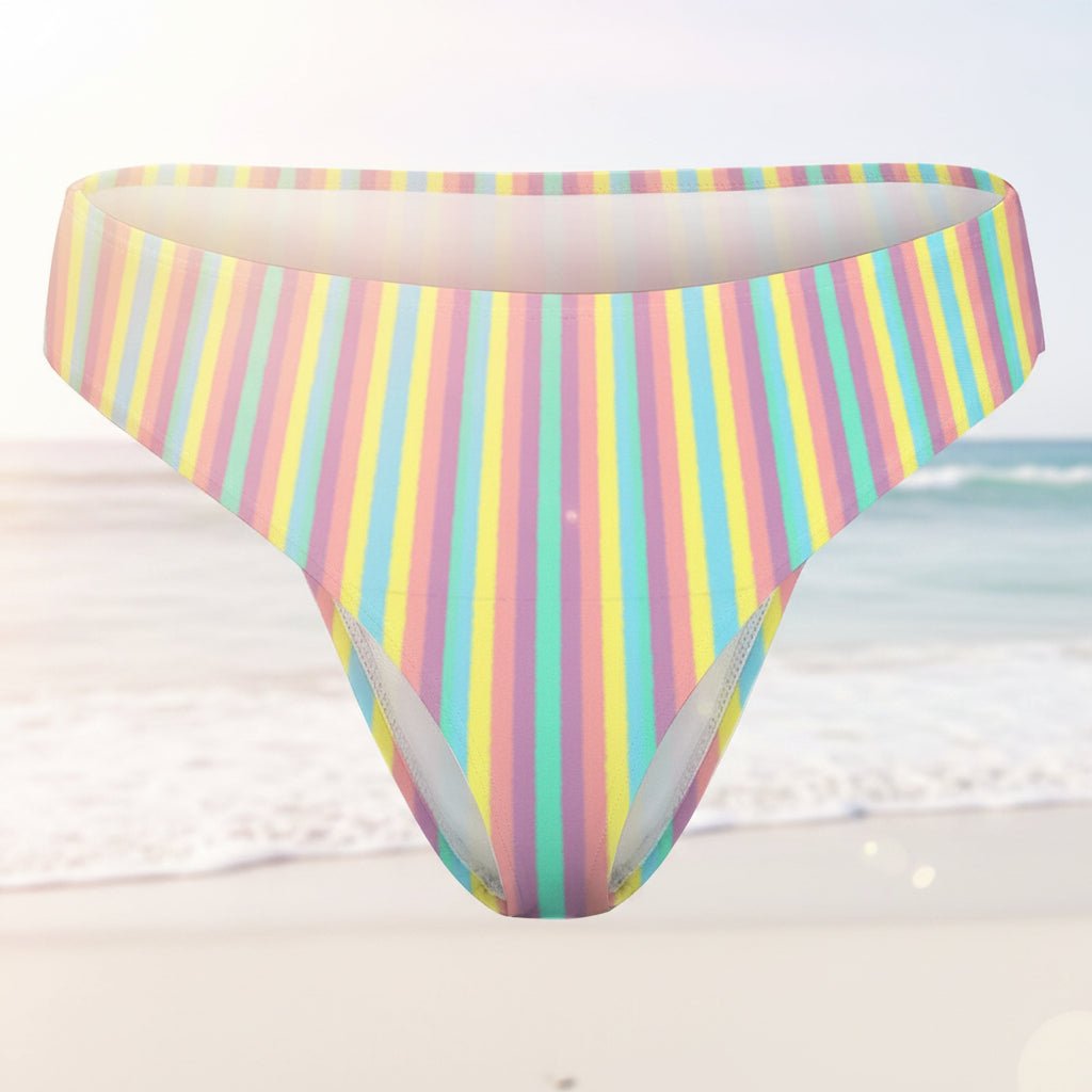 Multicolored striped bikini bottom on a faded beach background
