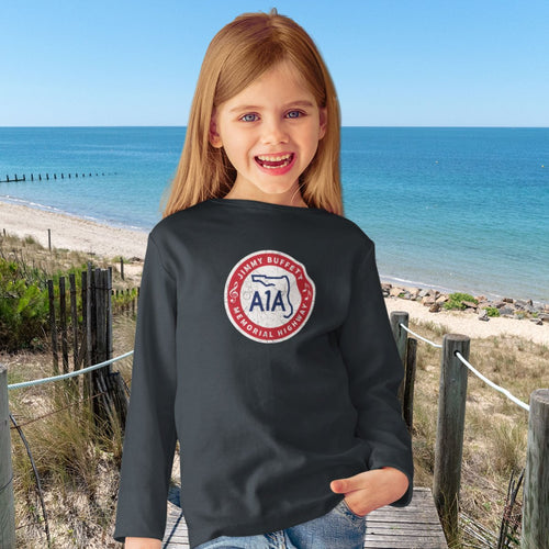 Child wearing a black sweatshirt with a A1A Sign on a beach