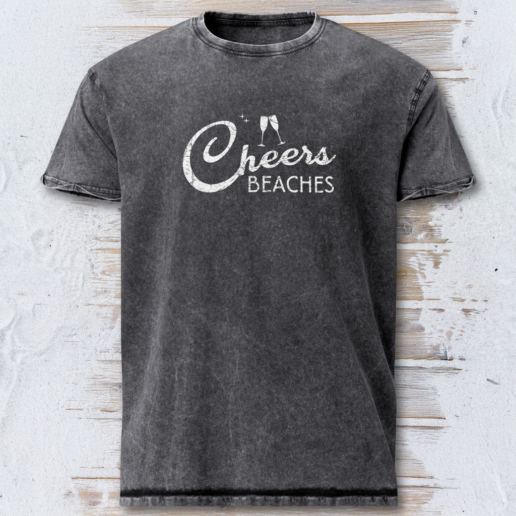 Gray t-shirt with 'Cheers Beaches' text on a textured surface