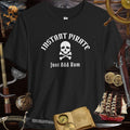 Instant Pirate Just Add Rum Unisex Bella Canvas Tee Shirt on a black background with pirate themed decorations.