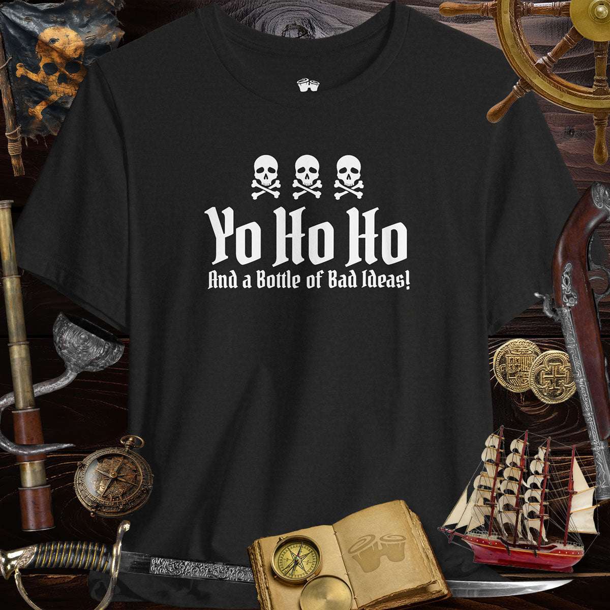 Yo Ho Ho And A Bottle Of Bad Ideas Skulls Graphic Tee for Pirate Lovers on black background with pirate props.