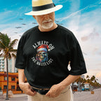 Man wearing a back funny-pirate-christmas-tee-with a graphic design on a beach background