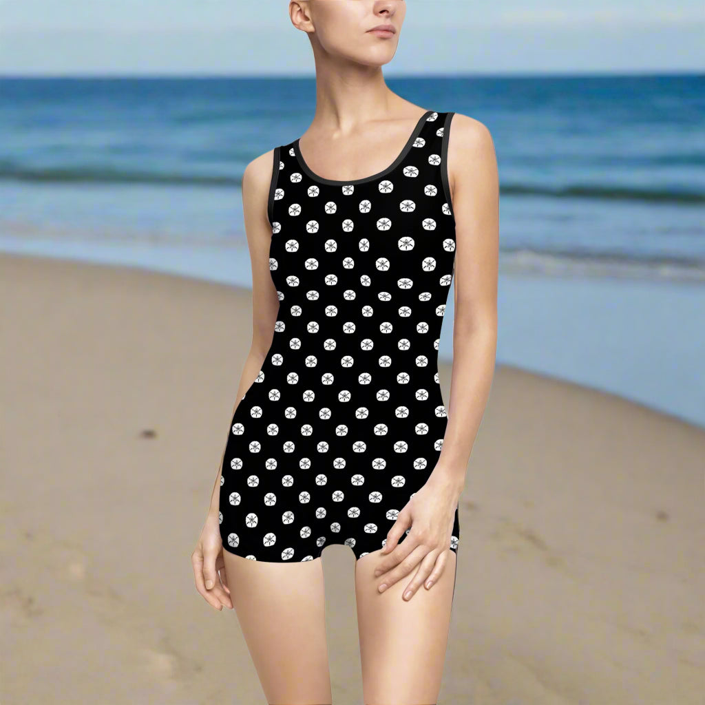 Standing sand where ocean meets land wering a Bong Beachwear exclusive sand-dollar polka dot pattern