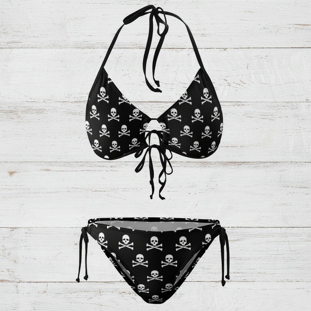 Black bikini set with skull and crossbones pattern on a white nautical wood background