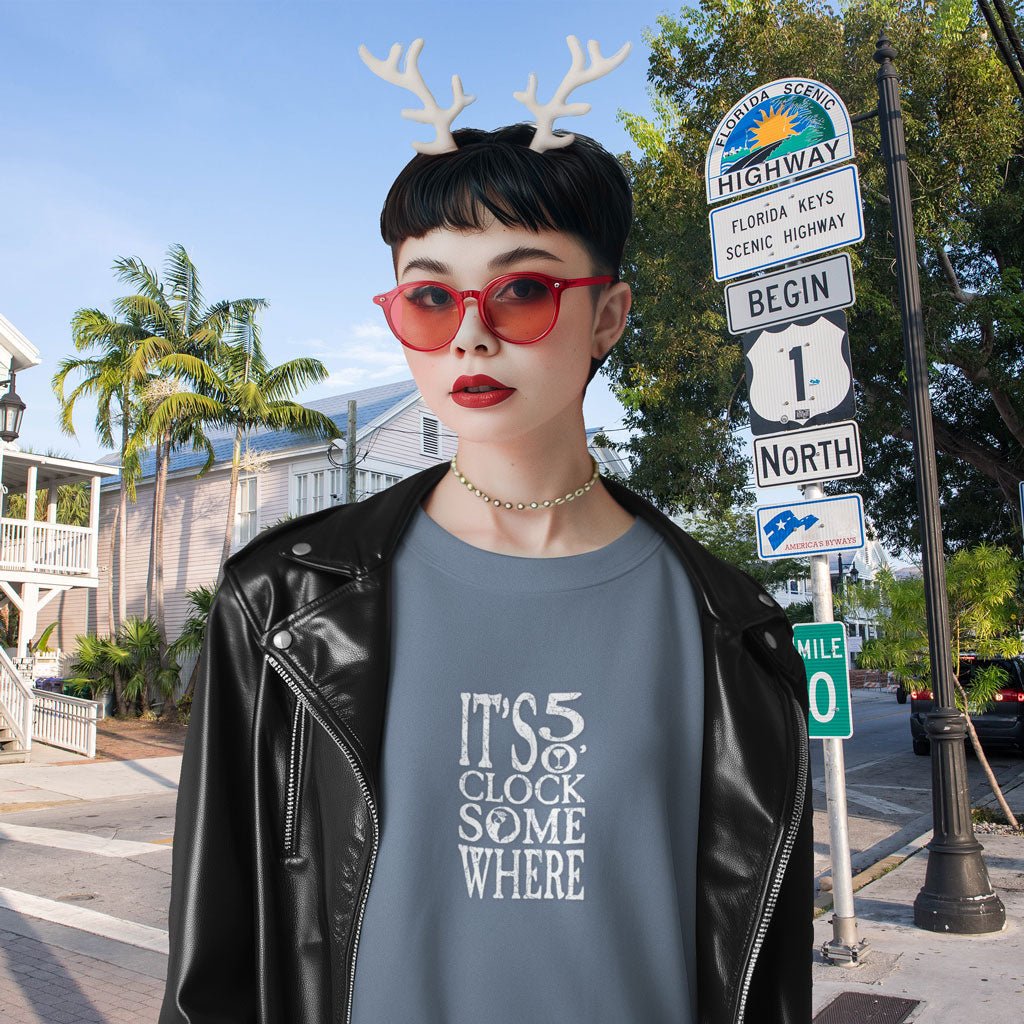 Person wearing red sunglasses, a black leather jacket and Rain-deer antlers in front of a Florida Scenic street sign