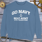 Blue sweatshirt with 'GO NAVY BEAT ARMY IT'S TRADITION' text on a wooden background with nautical items.