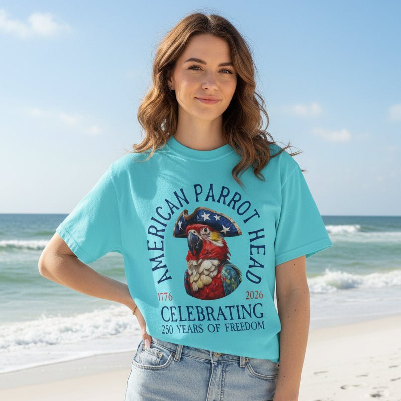 Women wearing a light blue t-shirt with a parrot head graphic and text, standing on Dayton Beach.