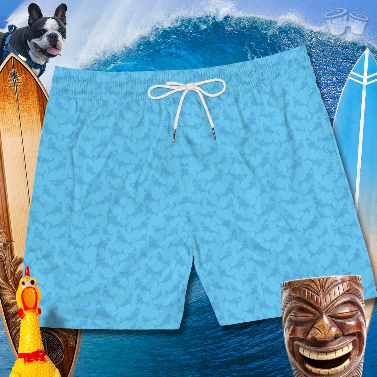 Front of Men's swim shorts with cool blue on blue shark pattern over a cresting wave and a couple of surfboards. 