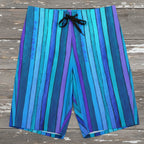 Blue striped board shorts laying flat on a rustic wood background
