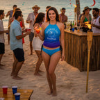 Woman in a blue bikini with a 'Bubbles Up' top at a beachside tiki bar.