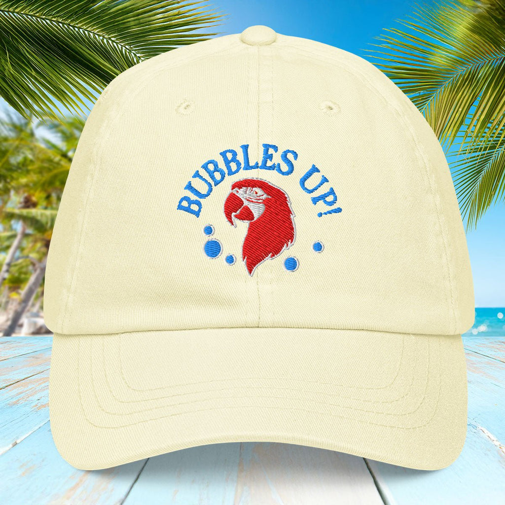 Lemon yellow cap with 'Bubbles Up!' design on a tropical background