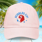 Pastel Pink cap with 'Bubbles Up!' text and red character design on a blue background with palm trees.
