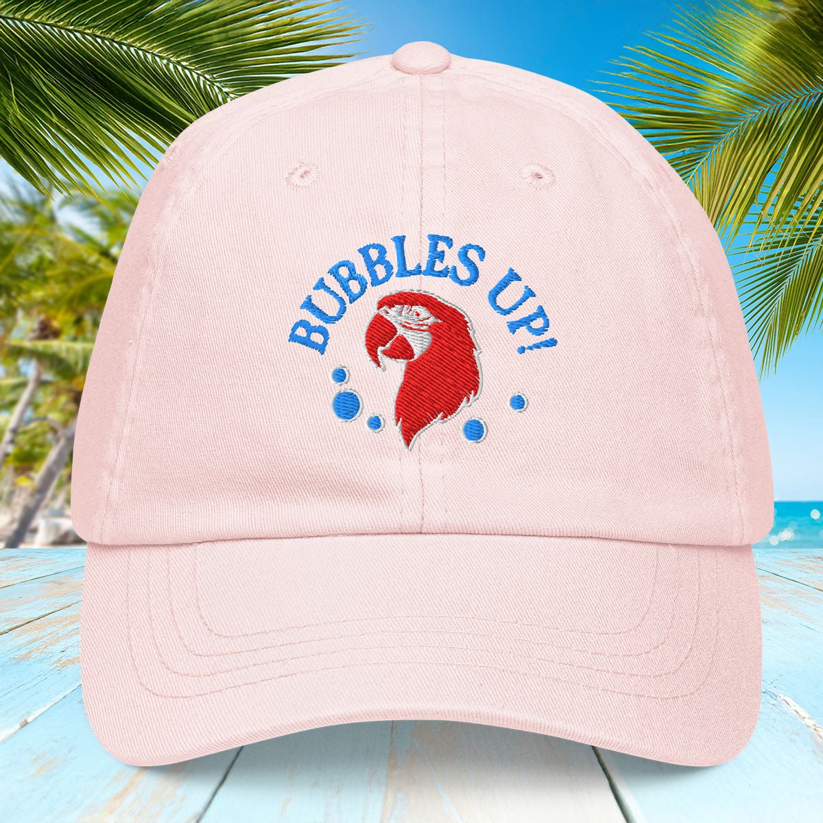 Pastel Pink cap with 'Bubbles Up!' text and red character design on a blue background with palm trees.