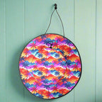 Colorful Sun Hat with black strap hanging on a hook in the wall of a beachside cafe'