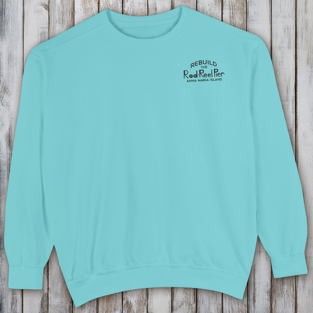 Light blue sweatshirt with text on a wooden surface