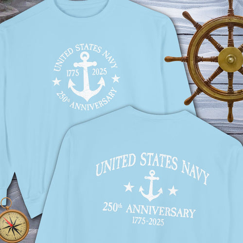 Light blue t-shirt with 'United States Navy 250th Anniversary' design, next to a wooden ship's wheel.