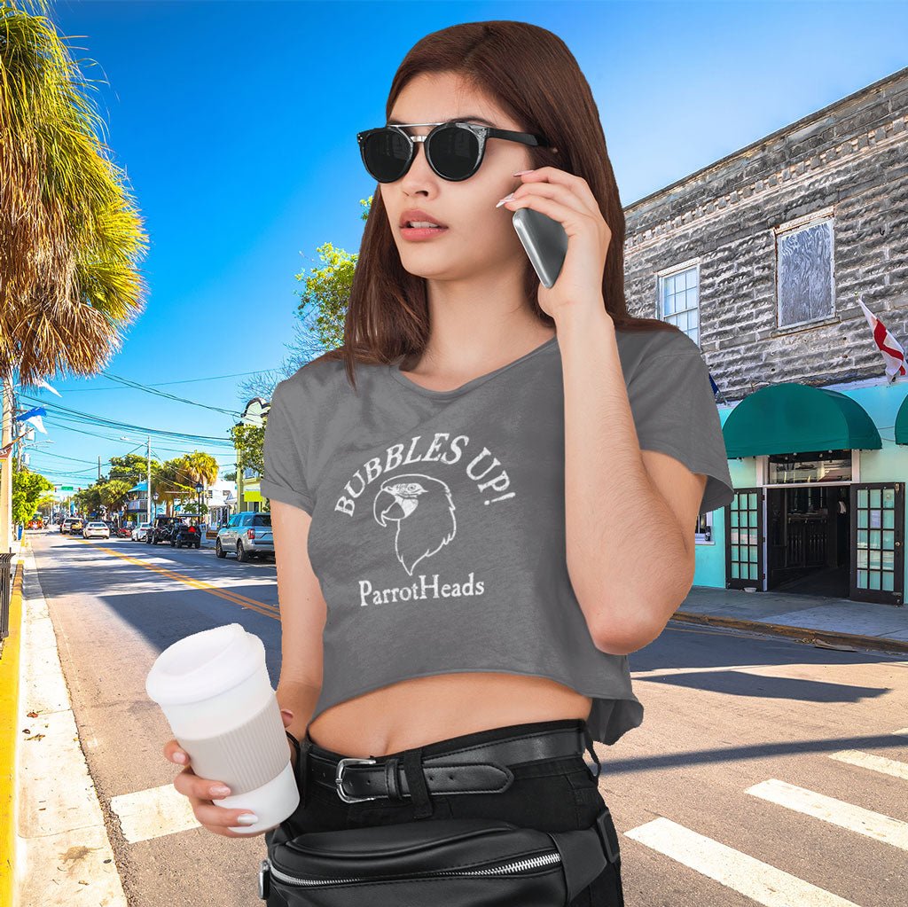 Woman on a city street in Key West wearing a gray t-shirt with 'Bubbles Up! ParrotHeads' text.