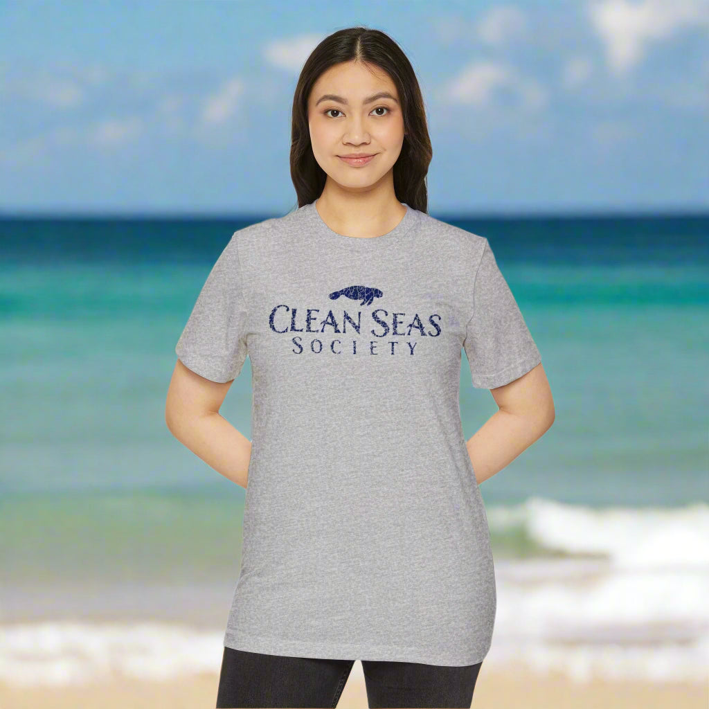 girl wearing a gray 'Clean Seas Society' t-shirt on a white background