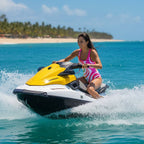 Woman wearing a colorful one-piece swimsuit riding a jet ski