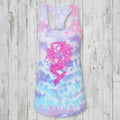 A women's racerback tank top featuring a pastel tie-dye pattern in pink, purple, and blue, with a large pink mermaid graphic printed on the front.