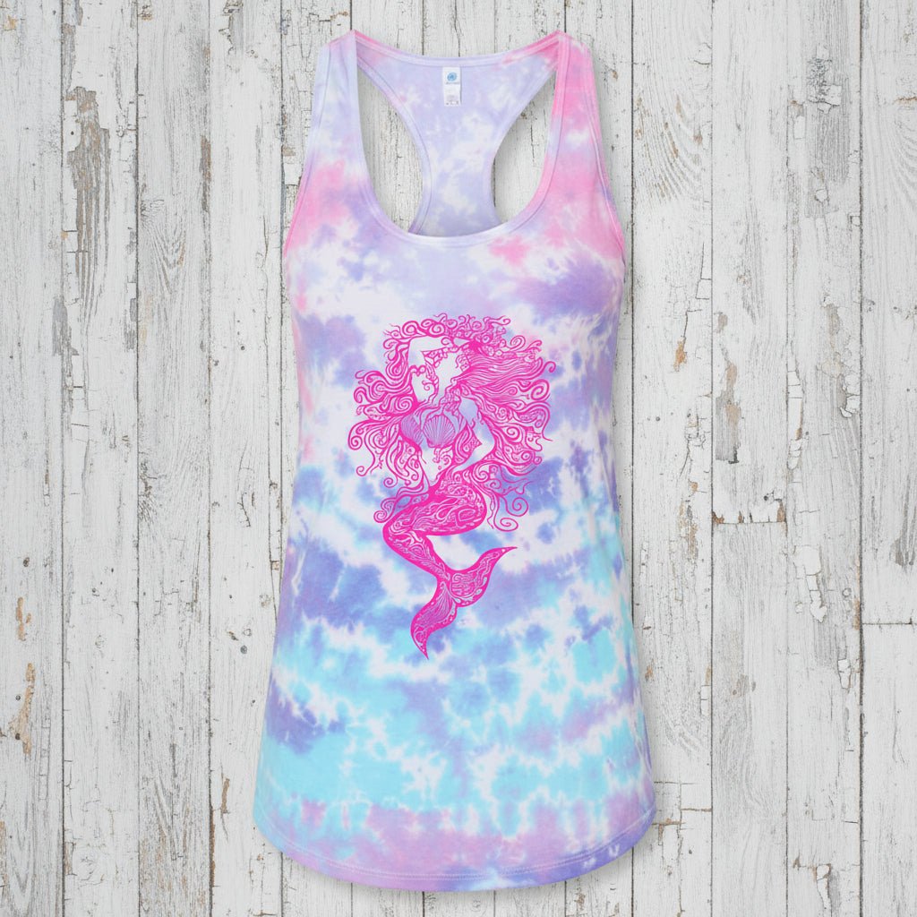 A women's racerback tank top featuring a pastel tie-dye pattern in pink, purple, and blue, with a large pink mermaid graphic printed on the front.