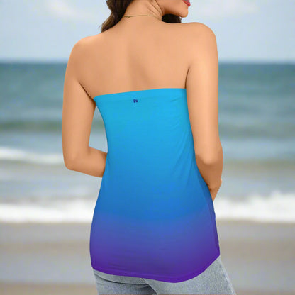 Woman wearing a strapless top with blue and purple gradient on a beach in St. Somewhere