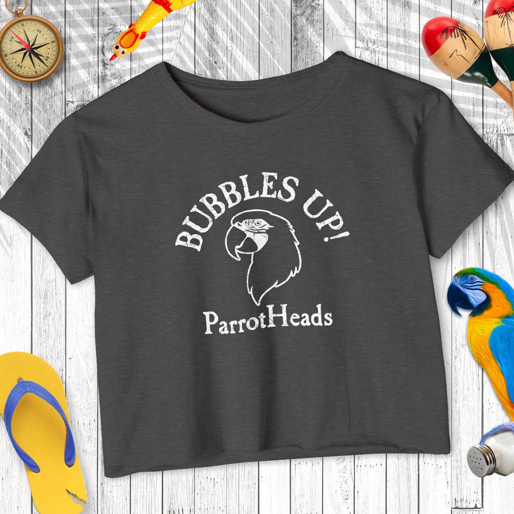 Dark gray t-shirt with 'Bubbles Up! ParrotHeads' text and parrot graphic on a wooden surface.