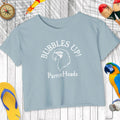 Light blue t-shirt with 'Bubbles Up! ParrotHeads' text and parrot graphic on a wooden surface.