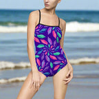Lady standing on the beach in a one piece swimsuit with junonia seashell pattern