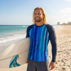 Man wearing a blue and black striped long-sleeve sun rashie on a white background