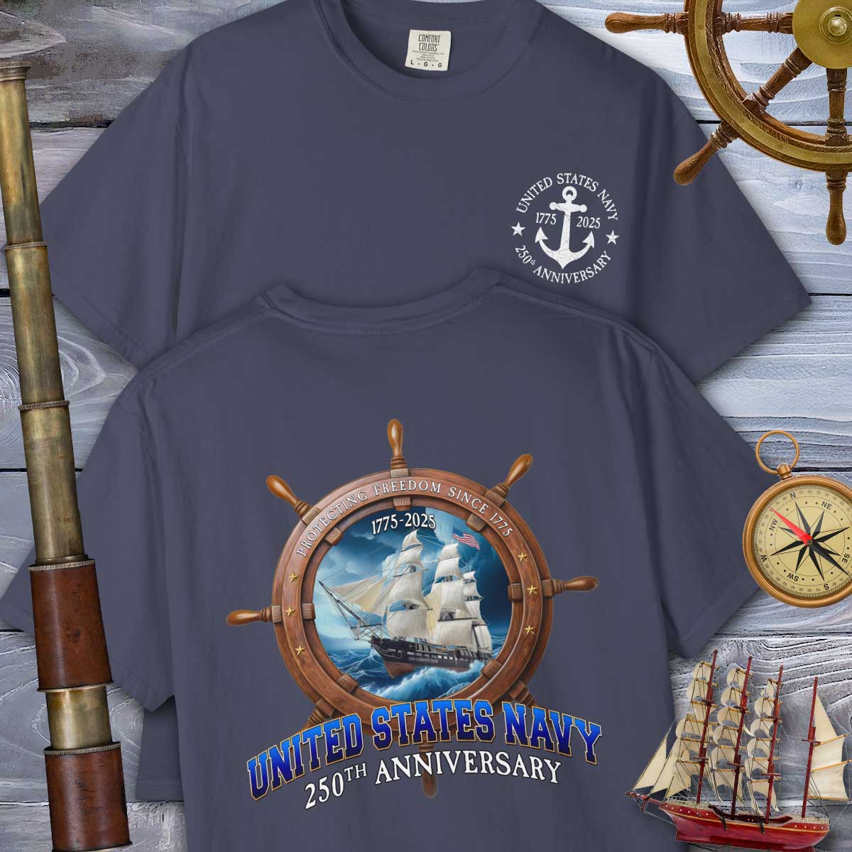 Navy blue t-shirt with United States Navy 250th Anniversary design on a wooden background with ship and compass elements.