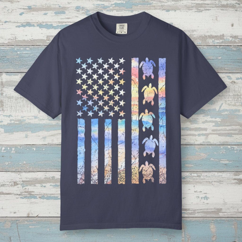 Navy blue t-shirt with a colorful American flag design featuring turtles on a nautical wood background